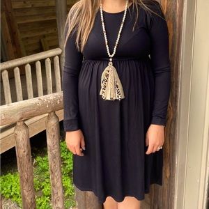 Black long sleeve knee length dress with pockets.